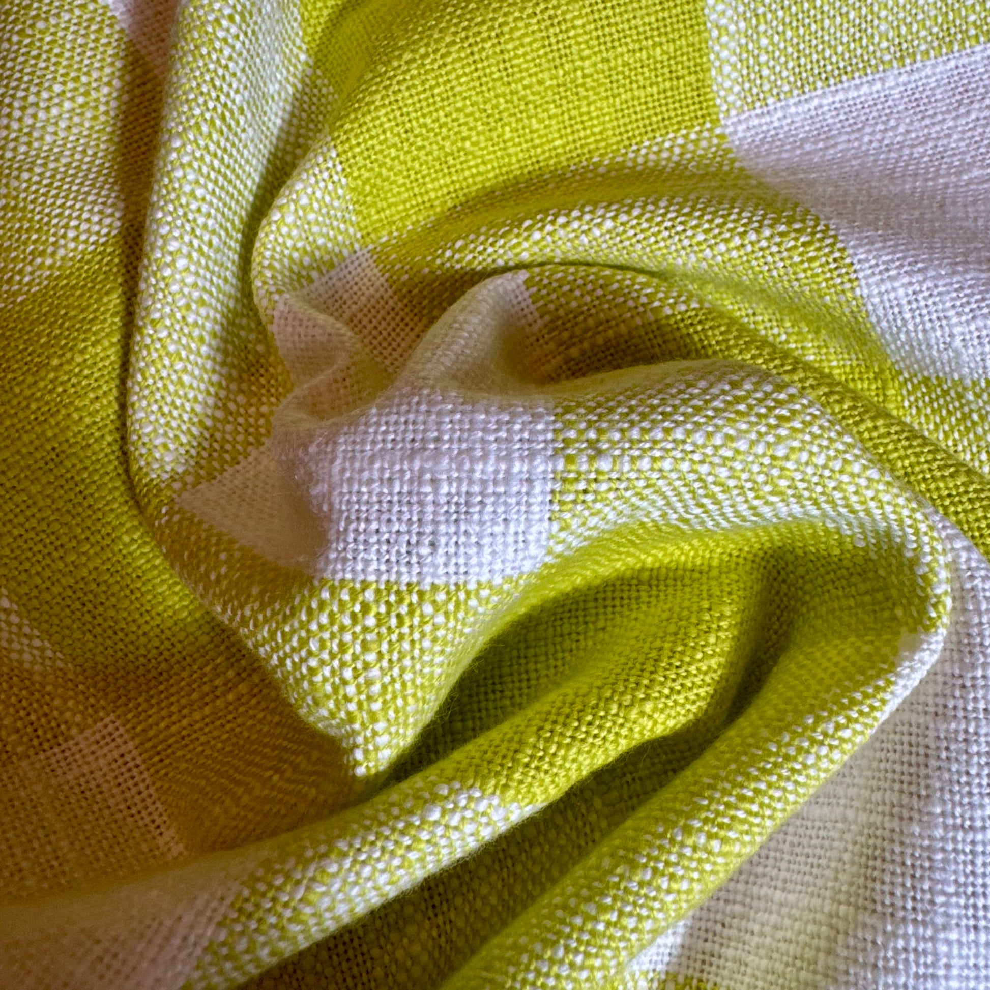 Macro detail of citron, cream, and blue plaid cotton toweling fabric folds showing thick slubbed weave