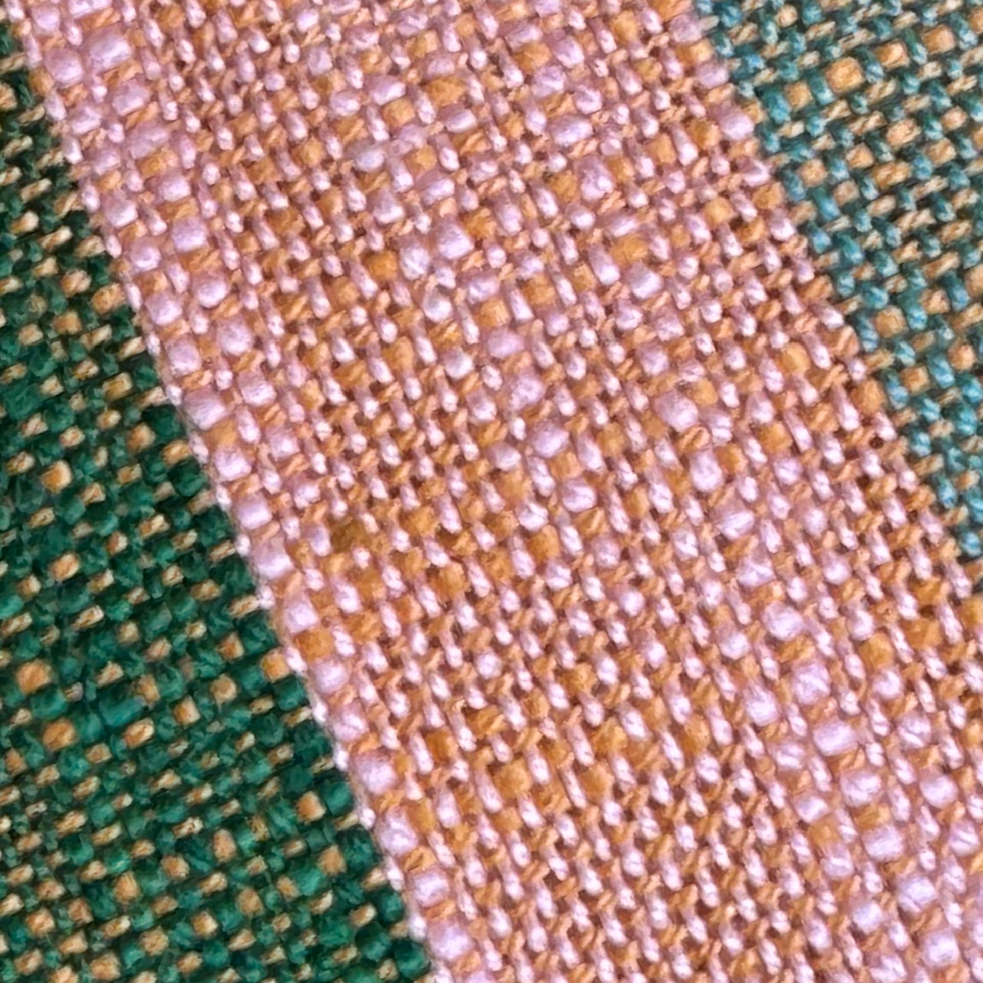 Close-up of coastal grandmother striped cotton fabric weave in green, rust, gold, blue, and cream